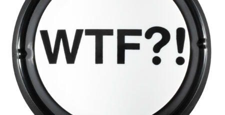 Top view of black and white WTF Button with large bold WTF?! text and black rim